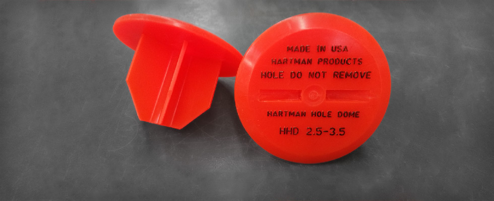 Hartman Hole Dome's flexible fins allow the hole plug to adjust to diameter of hole; OSHA required labeling on hole cover top