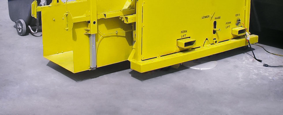 The Dumper: Fork Lift Aperture, 125V power inlet, & Wheel lever. Safety switch enables power only when firmly on the ground