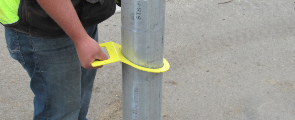 Hartman Bollard Remover quickly slides over a bollard, uses friction to grip it, and has an ergonomic handle to easily lift it