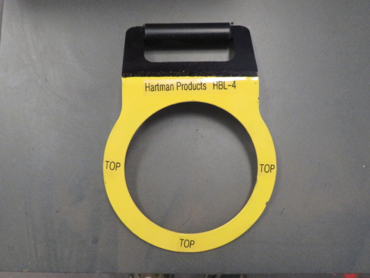 Top View of out Bollard Lifter for removing 4" pipe bollards. Labels show: "TOP" (for easy placement during use), the company name "Hartman Products", and the product number "HBL-4".
